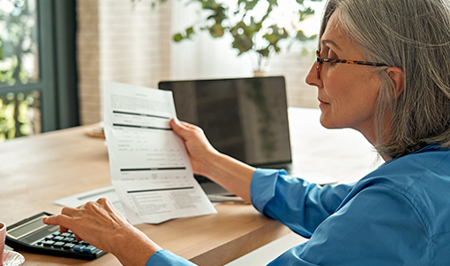 illustration of a woman at her computer making a payment online